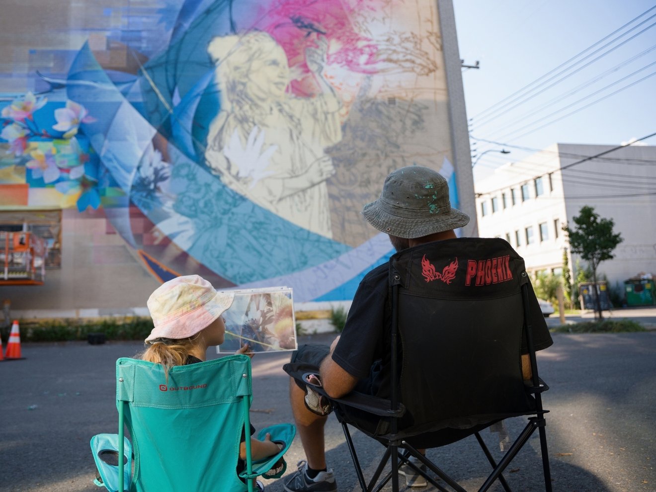 Fluke and Amaya in front of mural