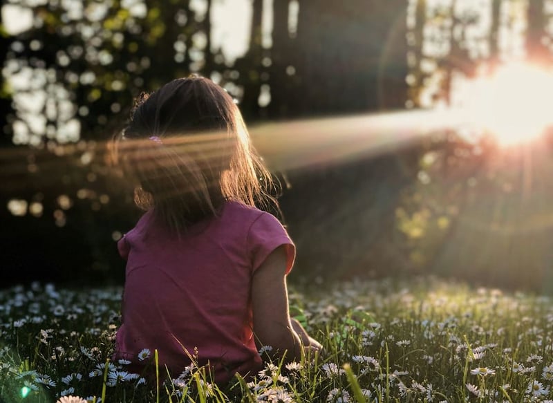 A child sitting outside in nature