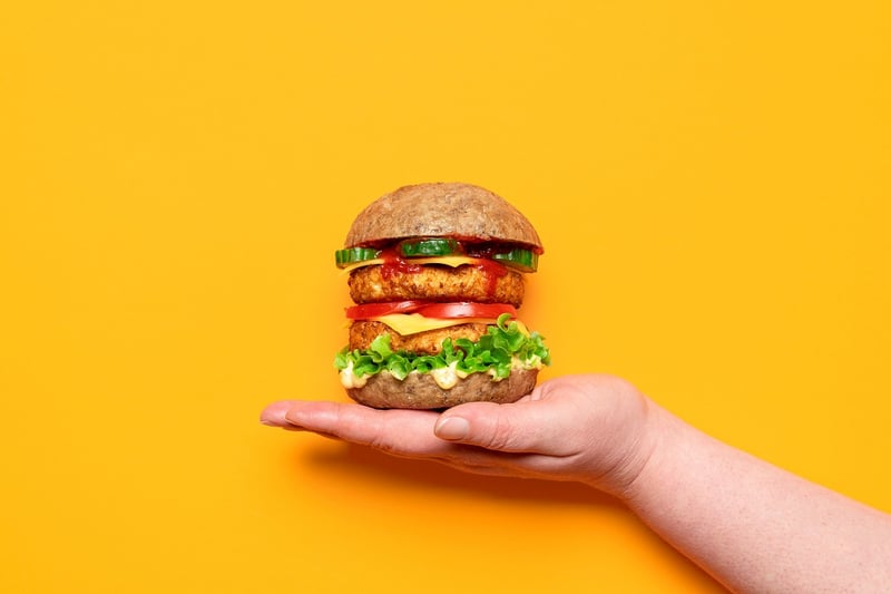 A hand holding up a veggie burger