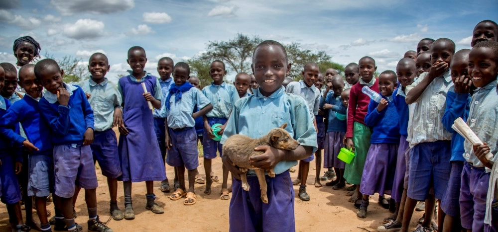 Child with dogs in Kenya