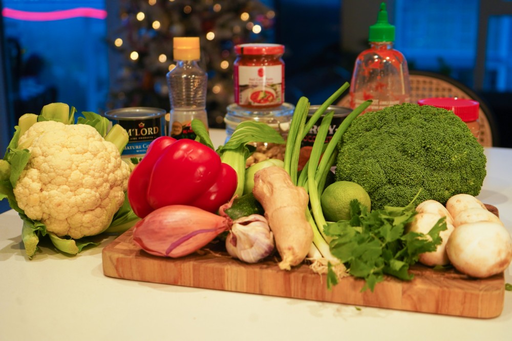 A table full of vegetables and ingredients for Coconut Thai Curry